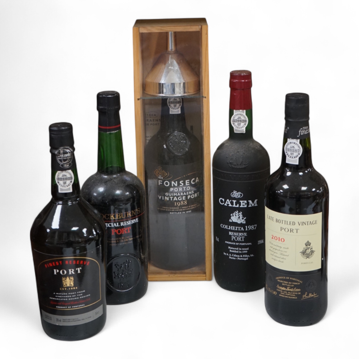 Five assorted bottles of port, including a boxed Fonseca 1988, a bottle of Calem 1987 and three other bottles of port.